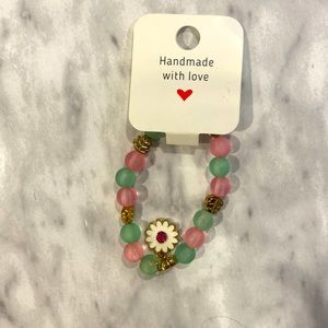 Kid’s size pink and green bracelet.